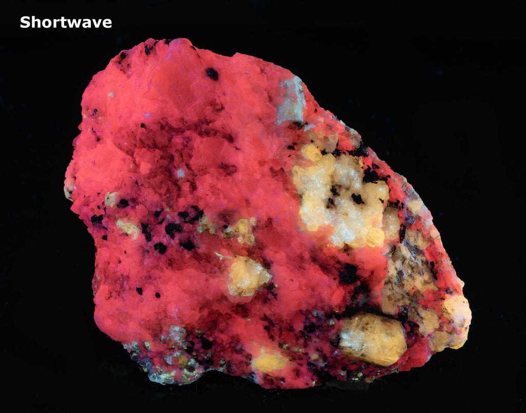 A nice specimen with Marialite (scapolite) crystals, fluorescent a bright yellow longwave, on a calcite matrix.