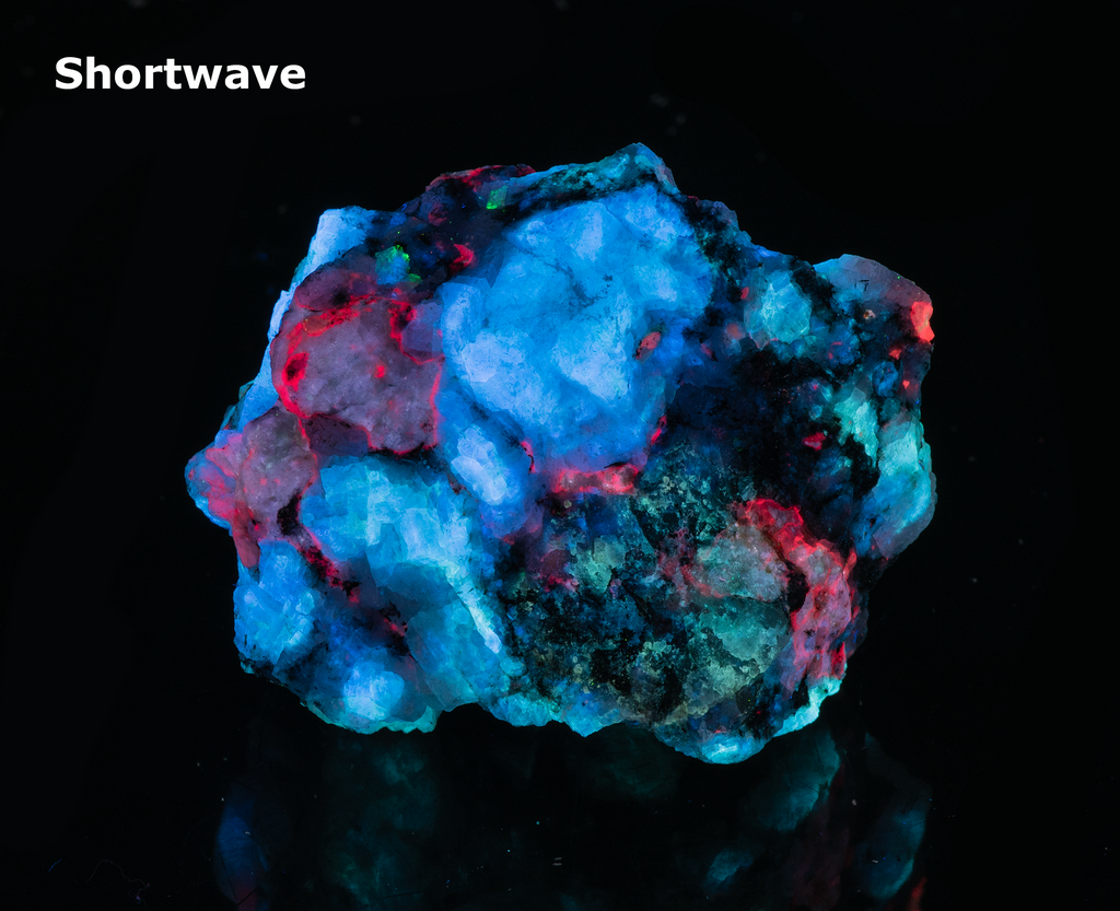A piece of our highly sought after "Fantasy Rock". This piece features rich tugtupite that fluoresces a deep cherry red under shortwave UV.