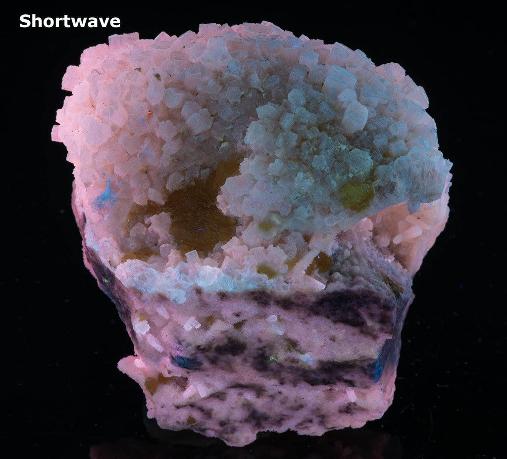 Yellow sulphur crystals sit atop an aragonite matrix