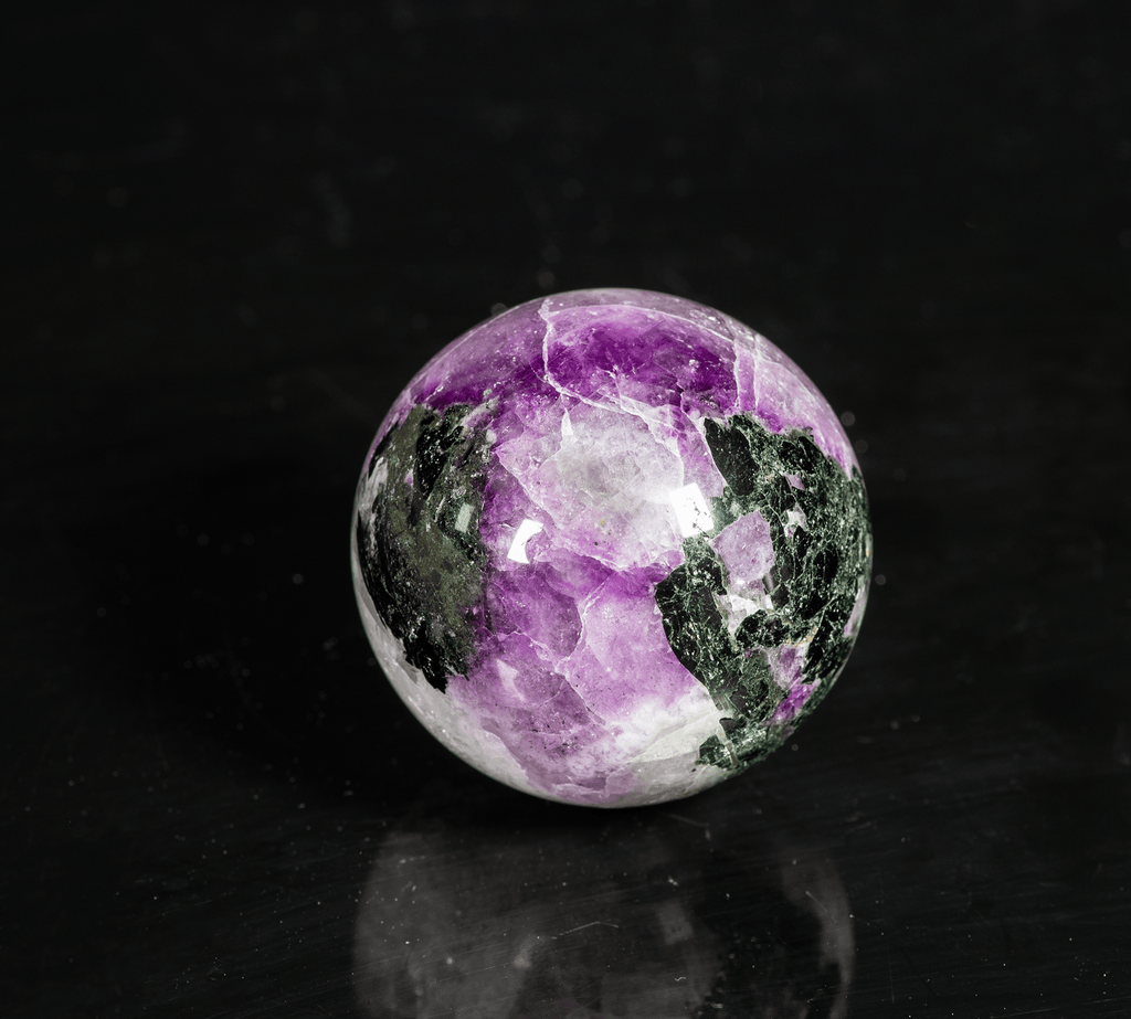 A nicely tenebrescent sodalite (hackmanite) sphere from Greenland