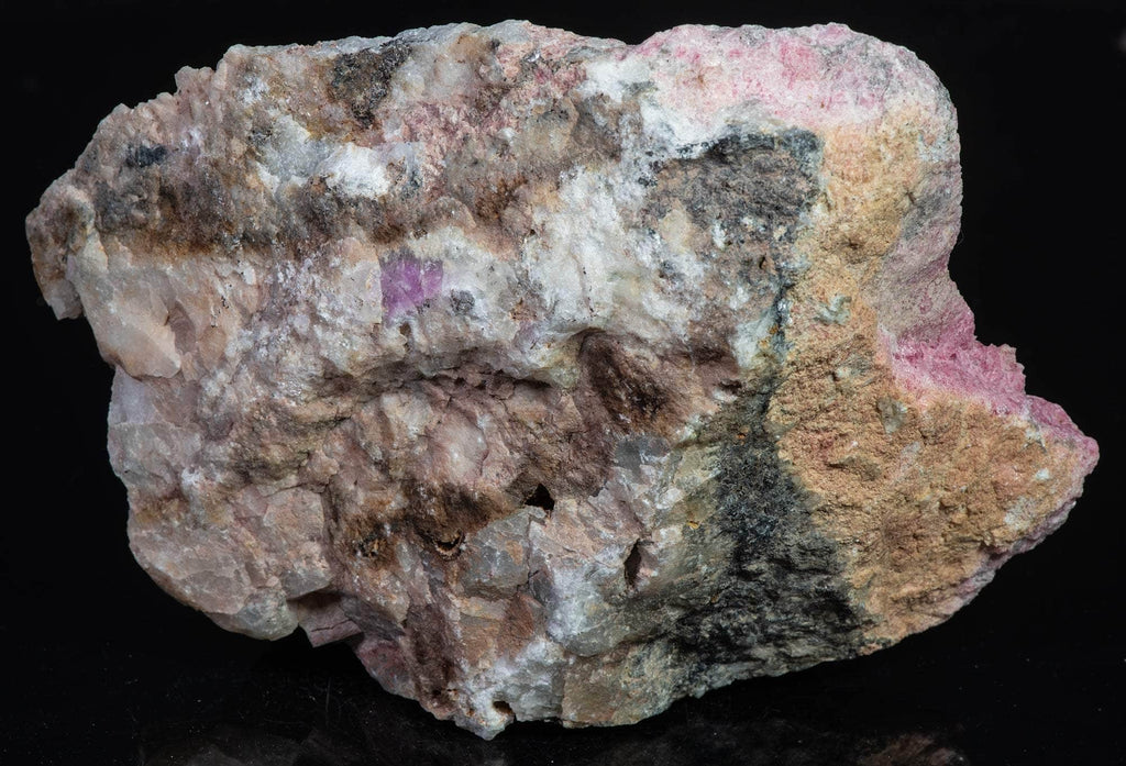 An incredible, unusual gemmy and extremely tenebrescent tugtupite specimen from Kangerlussaq. Vugs with large and well-formed, gemmy tugtupite crystals 