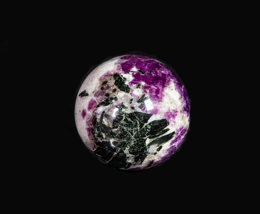 An incredibly bright and colorful, fluorescent sodalite sphere from Greenland