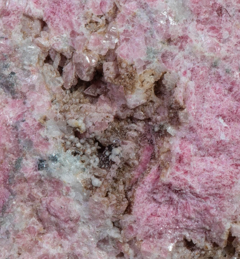 An incredible, unusual gemmy and extremely tenebrescent tugtupite specimen from Kangerlussaq. Vugs with large and well-formed, gemmy tugtupite crystals 