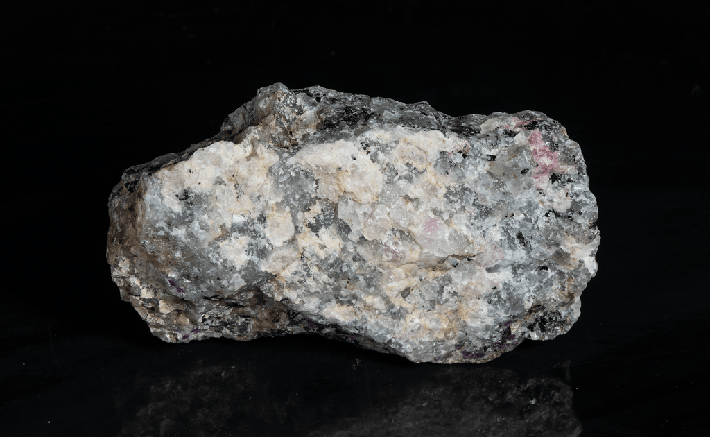 A piece of our highly sought after "Fantasy Rock". This piece features rich tugtupite that fluoresces a deep cherry red under shortwave UV.
