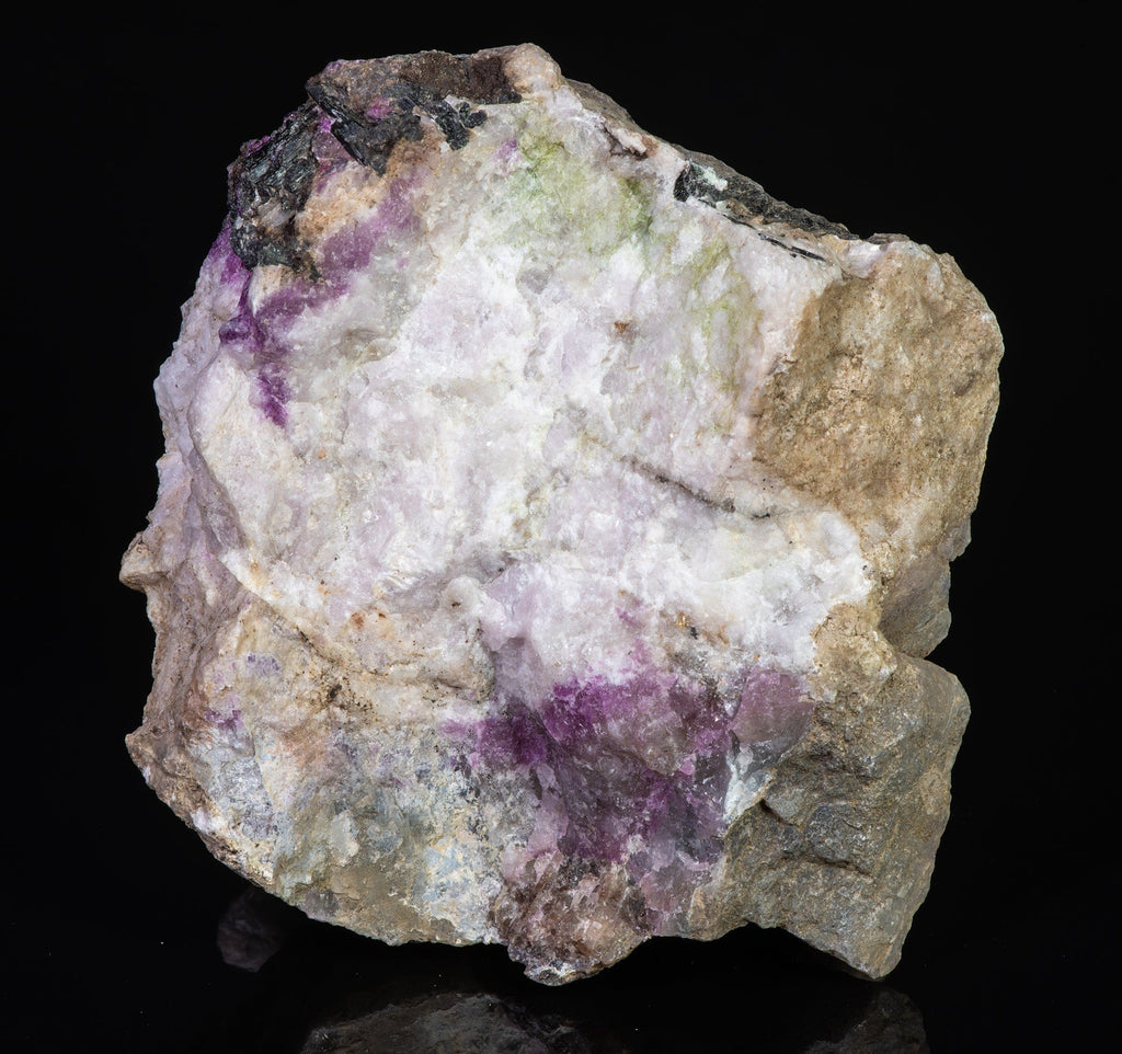 A mineral specimen of fluorescent sodaite with minor tugtupite from Greenland shown under UV light.