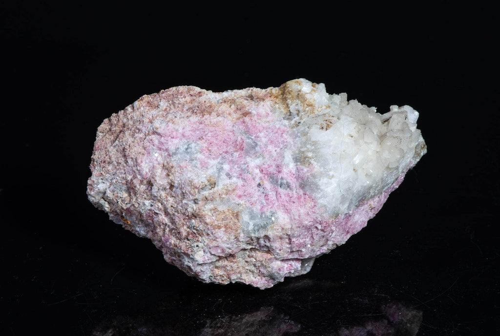 A smaller piece of our larger Kangerlussaq tugtupite specimens containing small tugtupite crystals dispersed throughout the matrix. 
