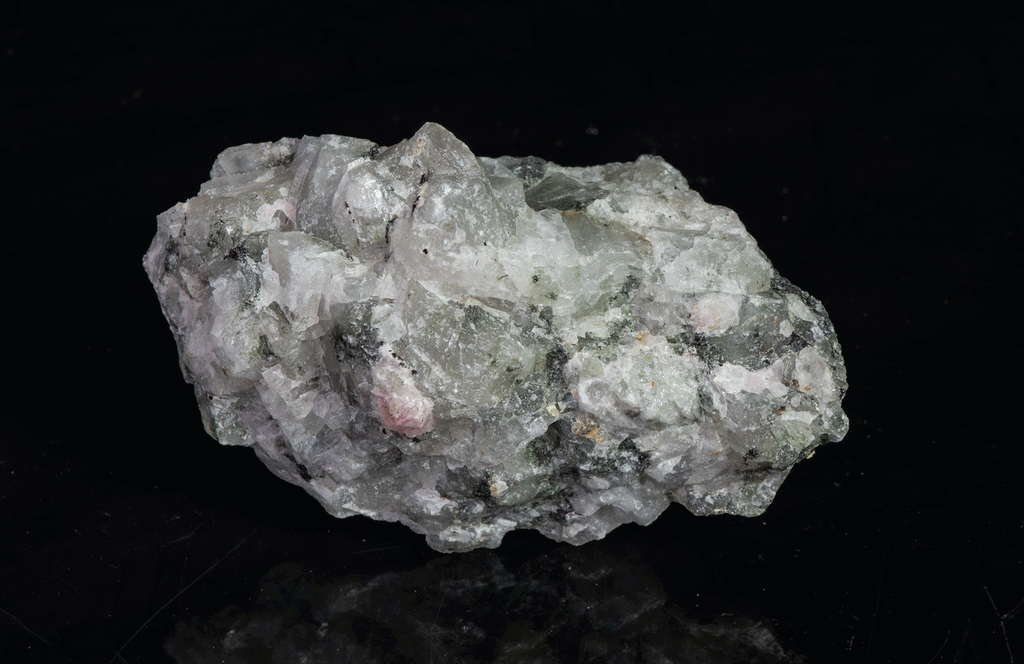 A piece of our highly sought after "Fantasy Rock". This piece features rich tugtupite that fluoresces a deep cherry red under shortwave UV.