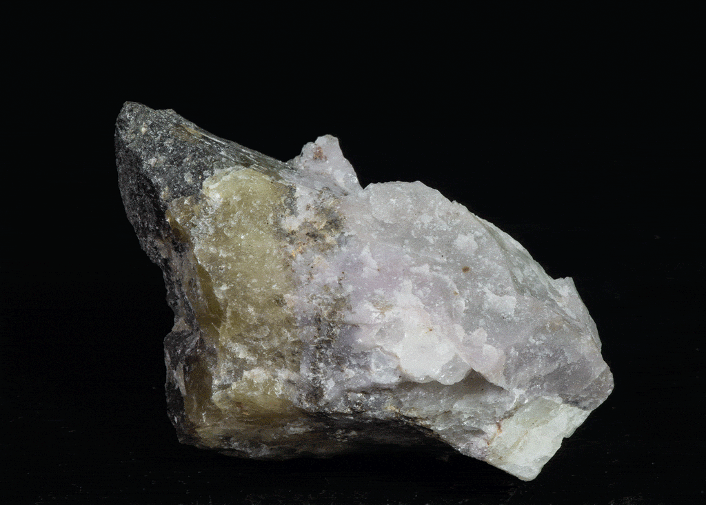 A mix of non-fluorescing ussingite and bright fluorescent sodalite, minor tugtupite from Greenland.