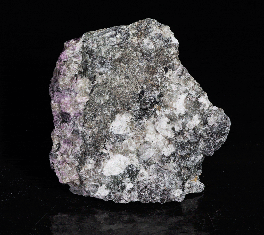A piece of our highly sought after "Fantasy Rock". This piece features rich tugtupite that fluoresces a deep cherry red under shortwave UV.
