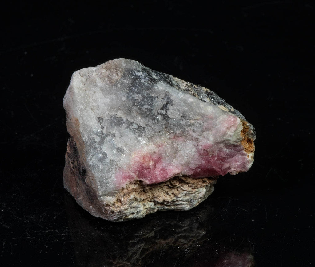 A classic piece of bright red fluorescent tugtupite 