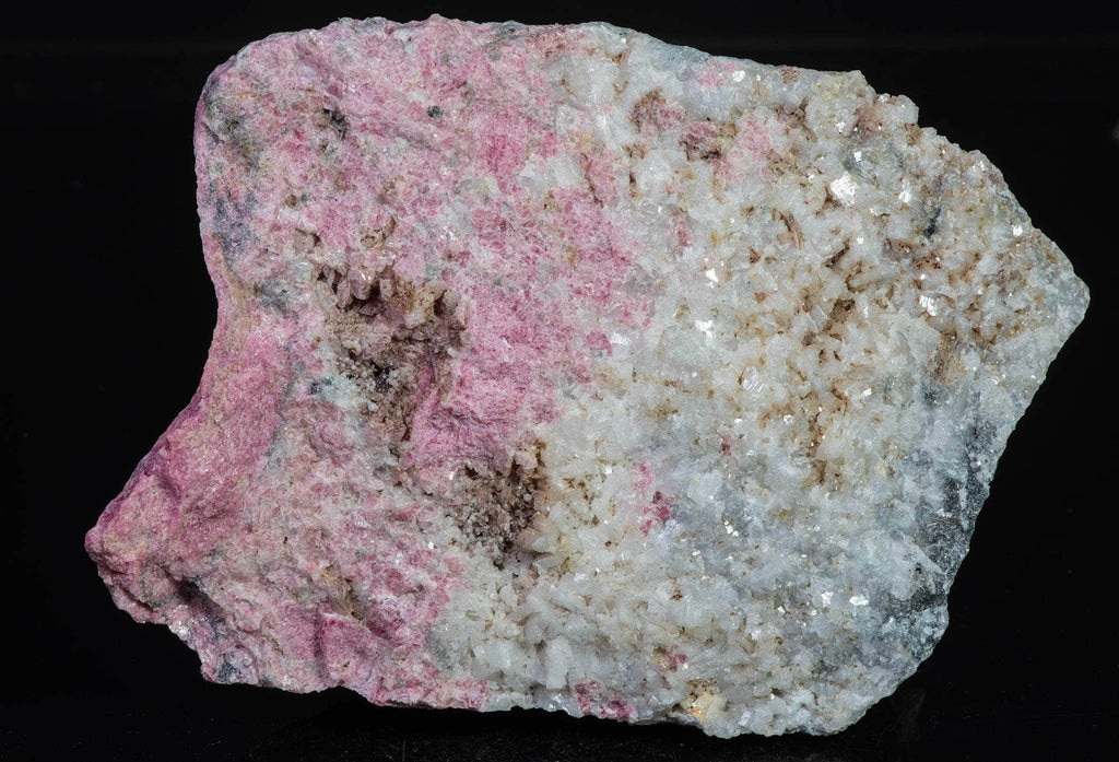 An incredible, unusual gemmy and extremely tenebrescent tugtupite specimen from Kangerlussaq. Vugs with large and well-formed, gemmy tugtupite crystals 