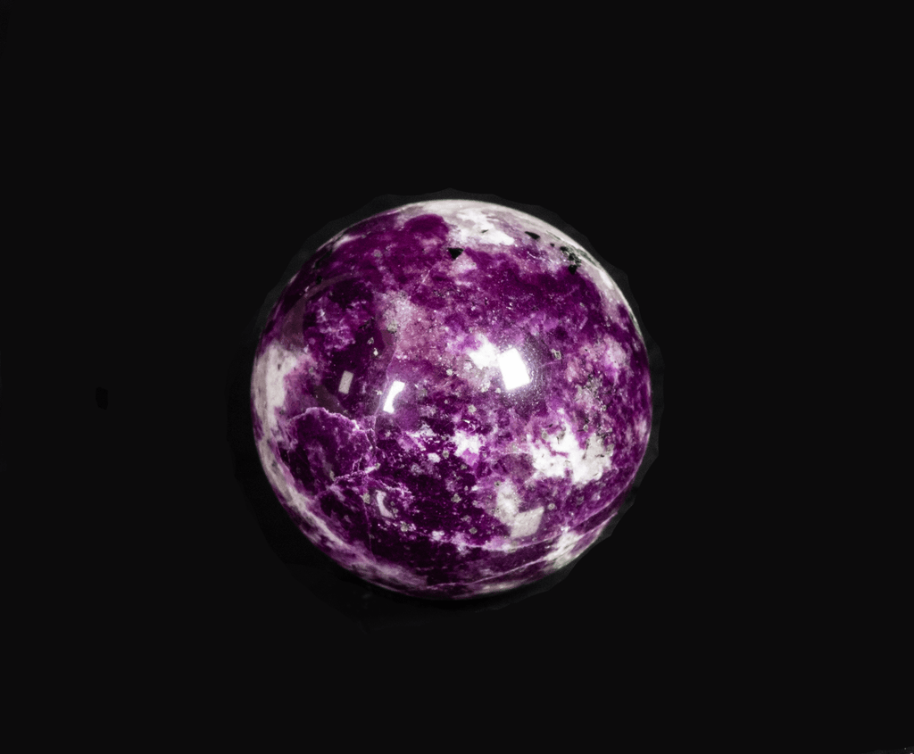 An incredibly bright and colorful, fluorescent sodalite sphere from Greenland