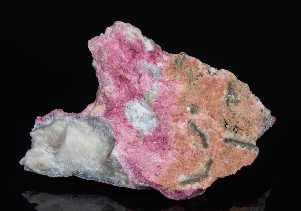 An incredible, unusual gemmy and extremely tenebrescent tugtupite specimen from Kangerlussaq.