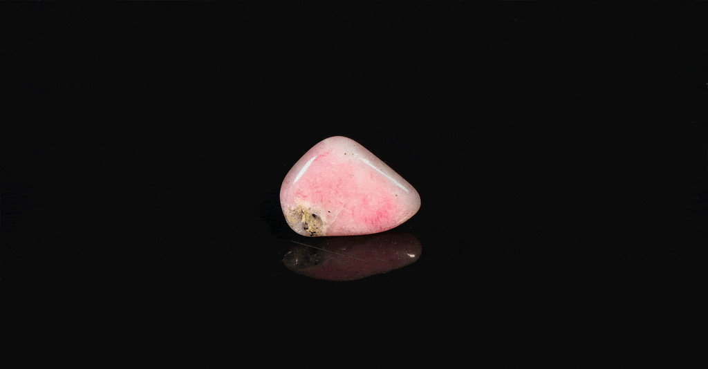 A piece of tumbled tugtupite showing tenebrescence