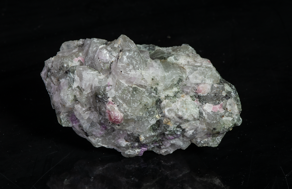 A piece of our highly sought after "Fantasy Rock". This piece features rich tugtupite that fluoresces a deep cherry red under shortwave UV.