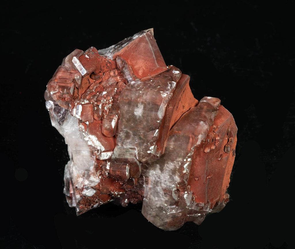 Reddish-brown chocolate calcite brightly fluorescing a red and purple under shortwave UV with excellent zoning