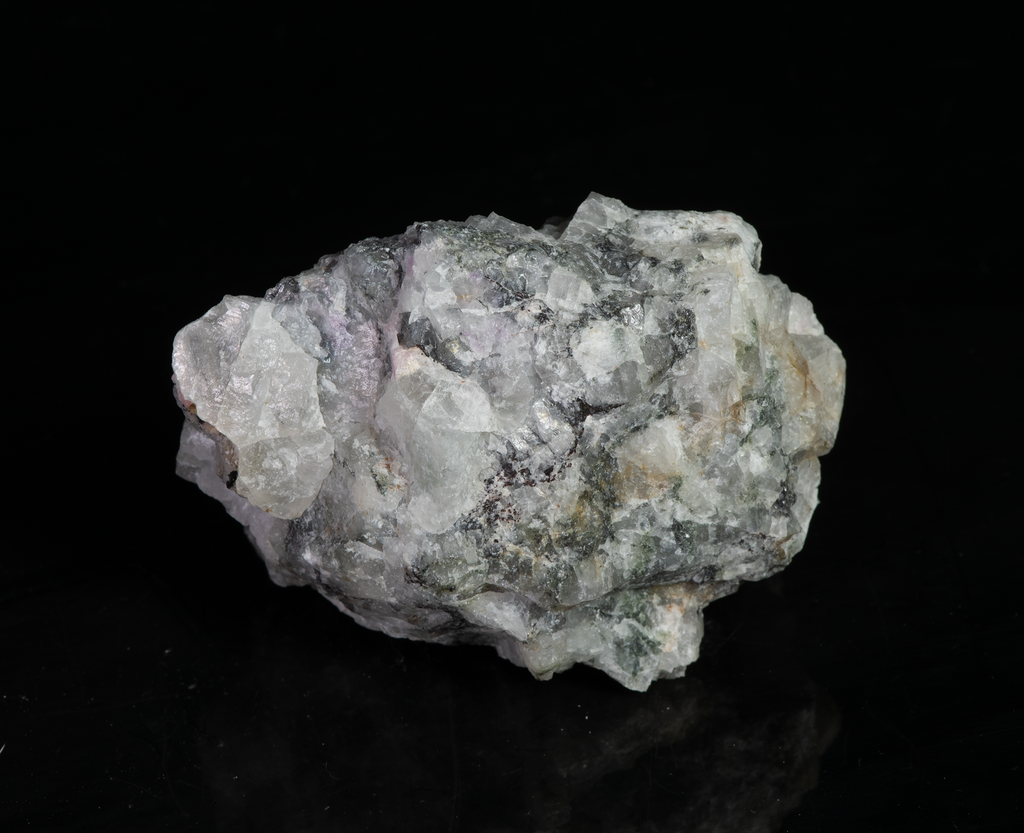 A piece of our highly sought after "Fantasy Rock". This piece features rich tugtupite that fluoresces a deep cherry red under shortwave UV.