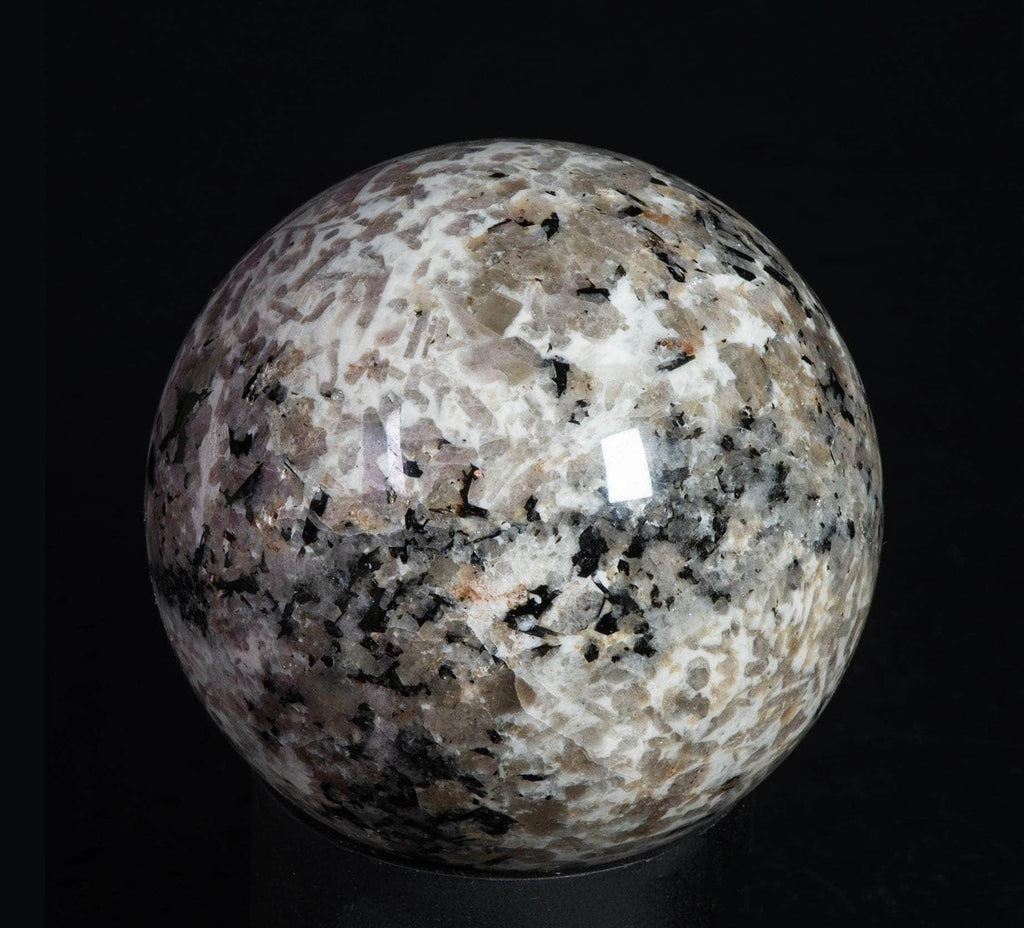 A sphere of fluorescent sodalite, brightest under longwave.