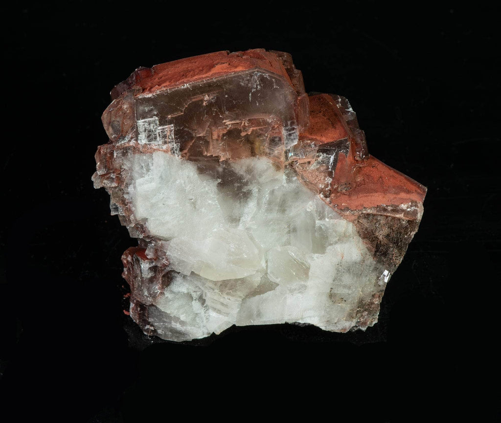 Reddish-brown chocolate calcite brightly fluorescing a red and purple under shortwave UV with excellent zoning