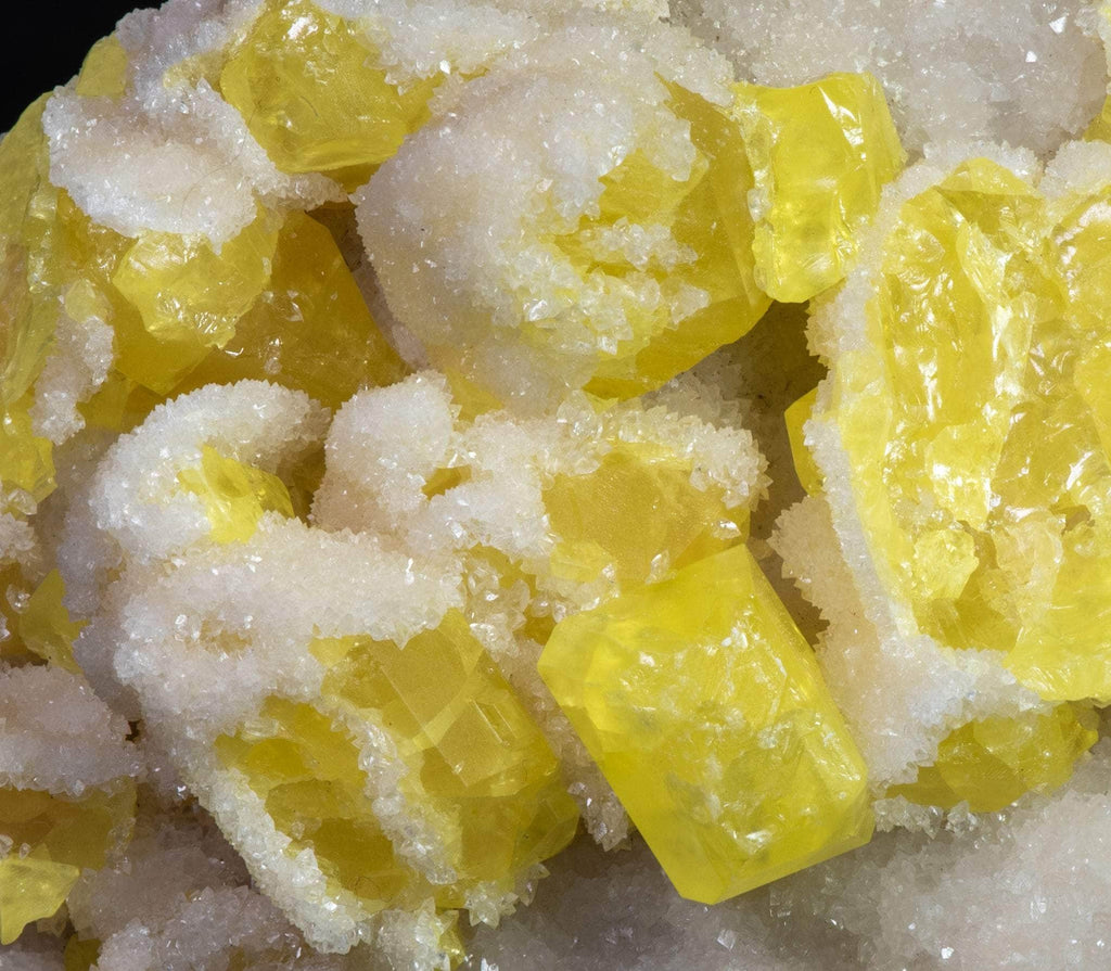 Yellow sulphur crystals sit atop an aragonite matrix