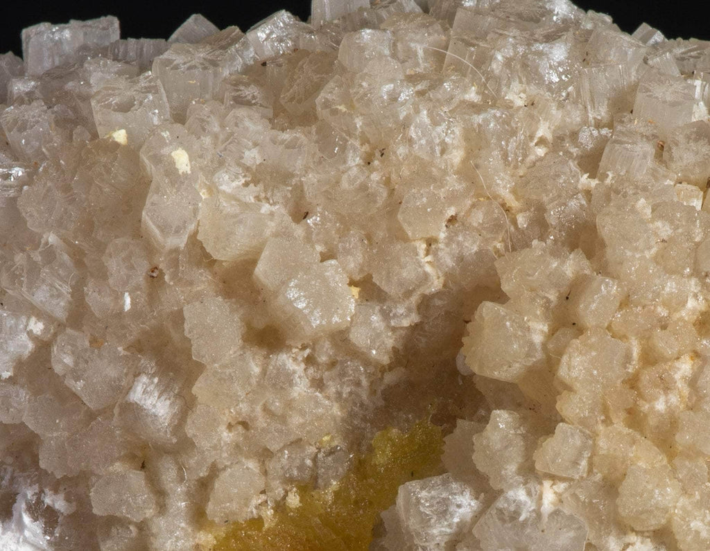 Yellow sulphur crystals sit atop an aragonite matrix