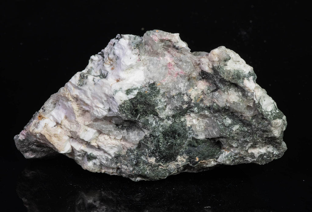 a fluorescent mineral specimen of tugtupite, chkalovite under white light