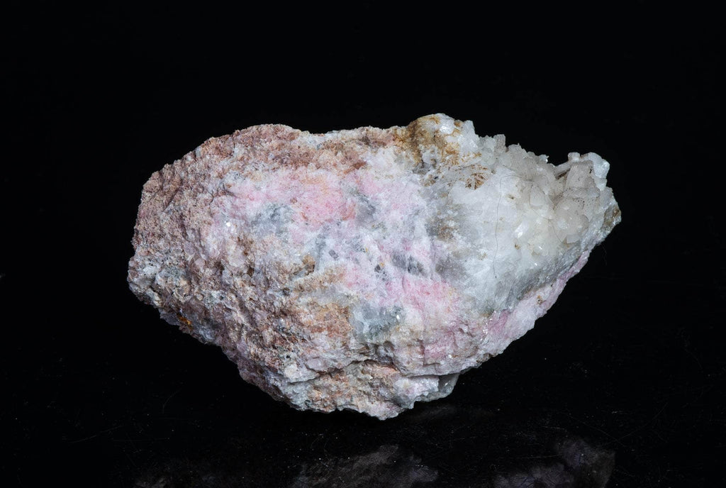 A smaller piece of our larger Kangerlussaq tugtupite specimens containing small tugtupite crystals dispersed throughout the matrix. 