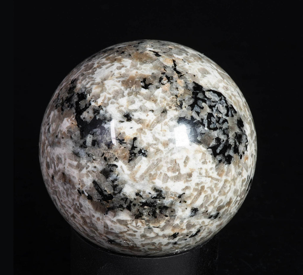 A sphere of fluorescent sodalite, brightest under longwave.