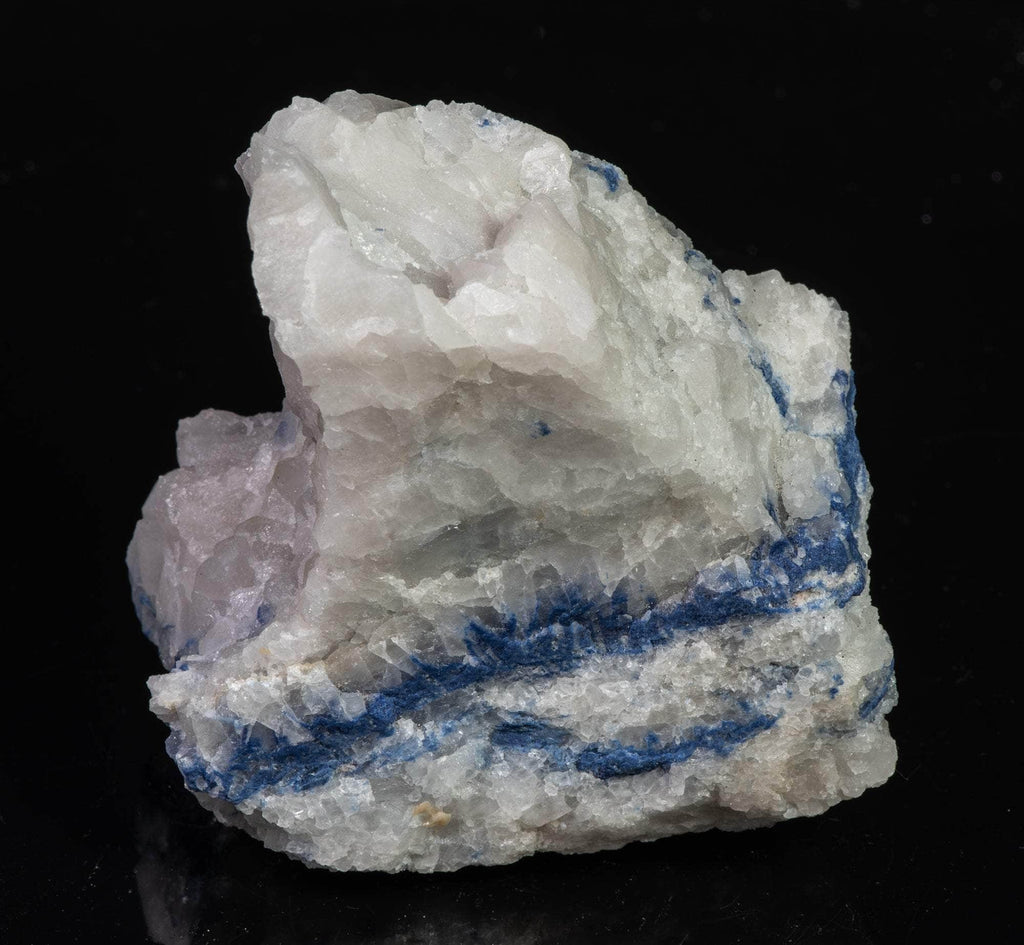 Blue dumortierite on top of a matrix of white quartz.