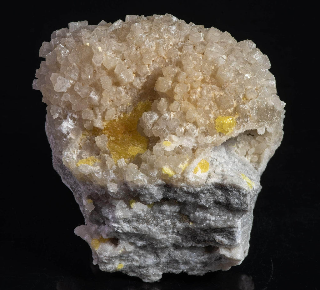 Yellow sulphur crystals sit atop an aragonite matrix