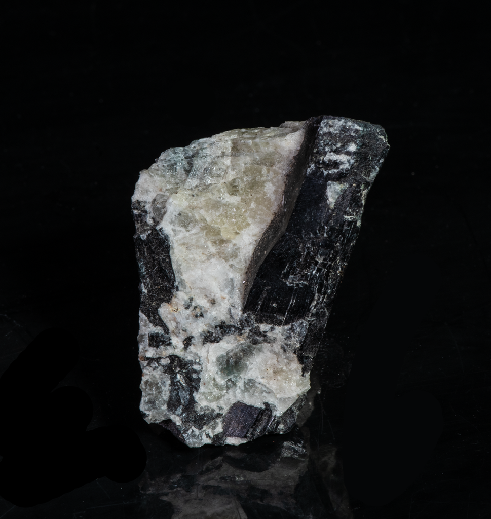 tenebrescent and fluorescent sodalite with an arfvedsonite crystal