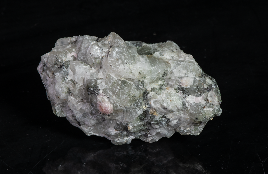A piece of our highly sought after "Fantasy Rock". This piece features rich tugtupite that fluoresces a deep cherry red under shortwave UV.