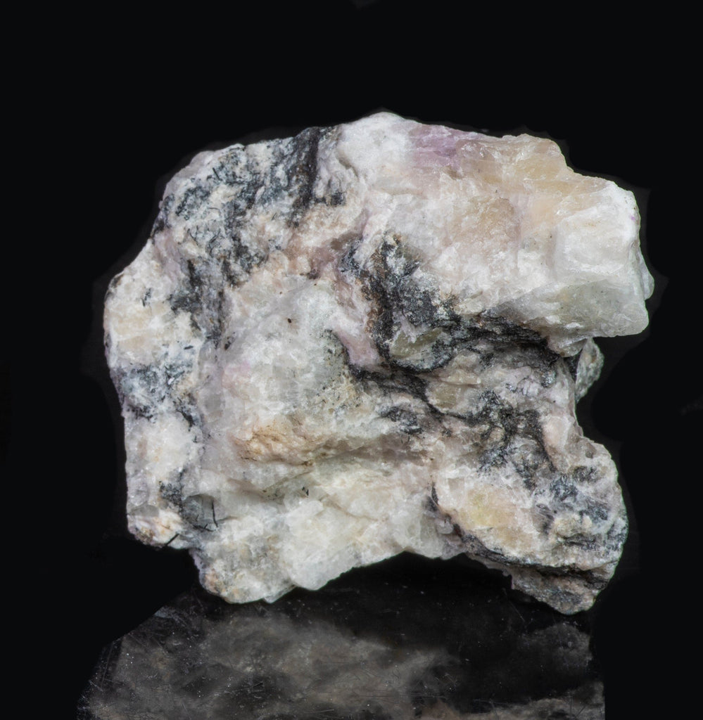 A large mineral specimen of fluorescing sodalite shown under all wavelengths