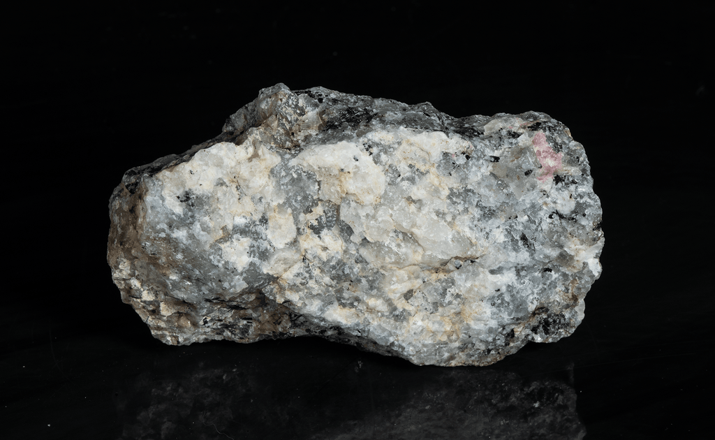 A piece of our highly sought after "Fantasy Rock". This piece features rich tugtupite that fluoresces a deep cherry red under shortwave UV.