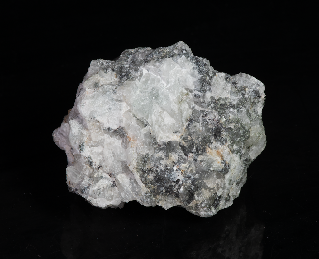 A piece of our highly sought after "Fantasy Rock". This piece features rich tugtupite that fluoresces a deep cherry red under shortwave UV.