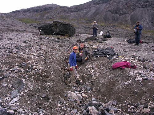 A group of people digging through a tugtupite vein