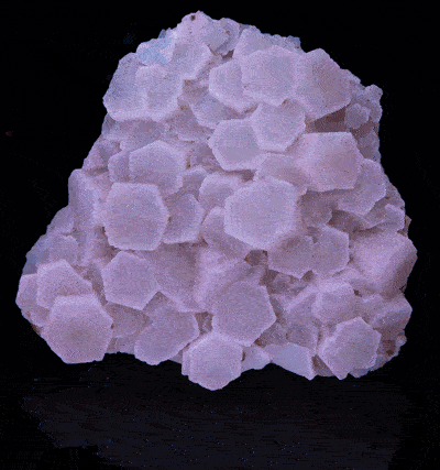 A piece of aragonite from Italy under various UV lights