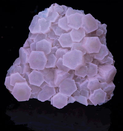 A piece of aragonite from Italy under various UV lights