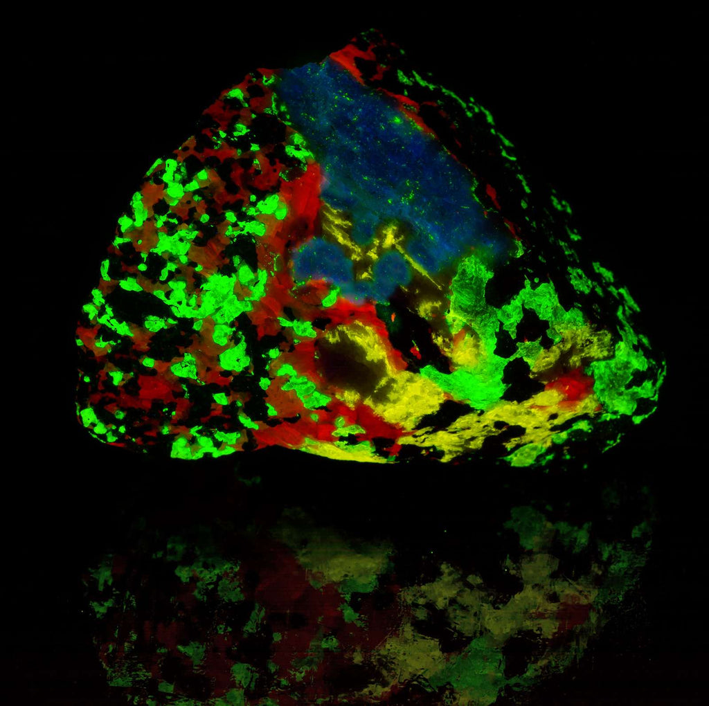 A piece of Esperite, Willemite, Calcite under shortwave UV light from Franklin, New Jersey