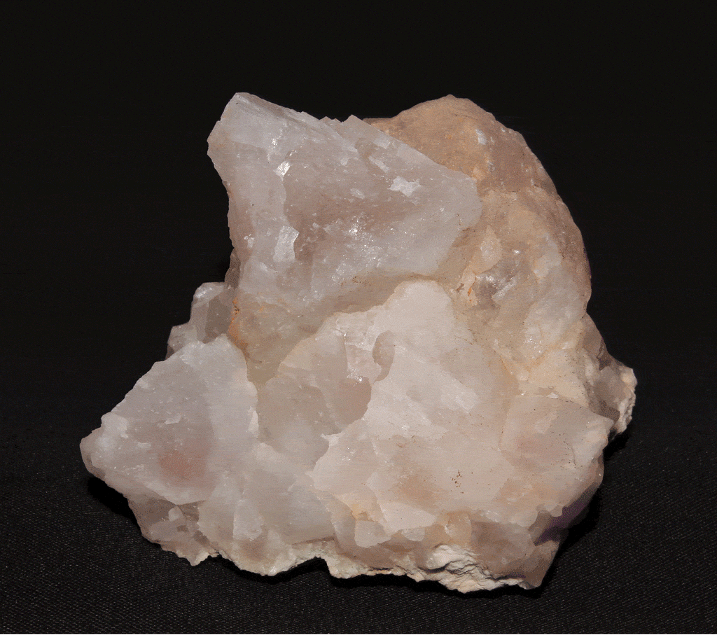 A fluorescent mineral shown under white light, shortwave, longwave and midwave light.