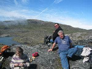 Group resting after mining rocks all today. One member examining a piece of tugtupite