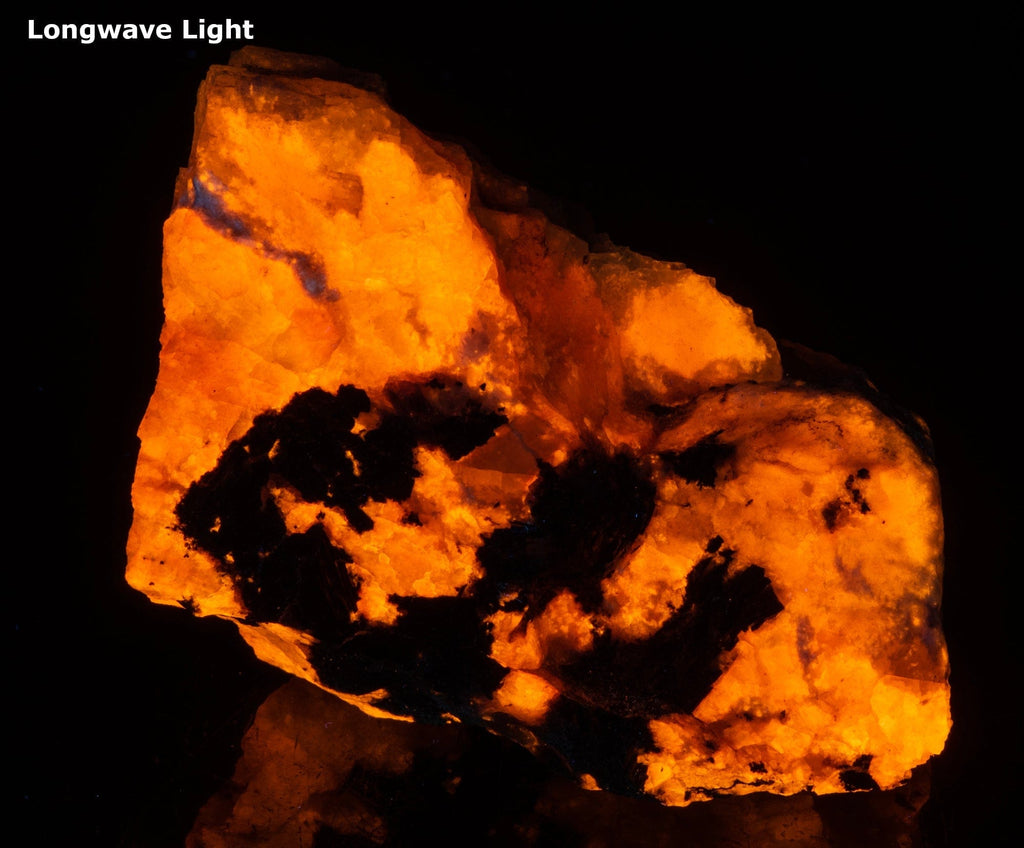 A piece of fluorescent sodalite with many unknown minerals