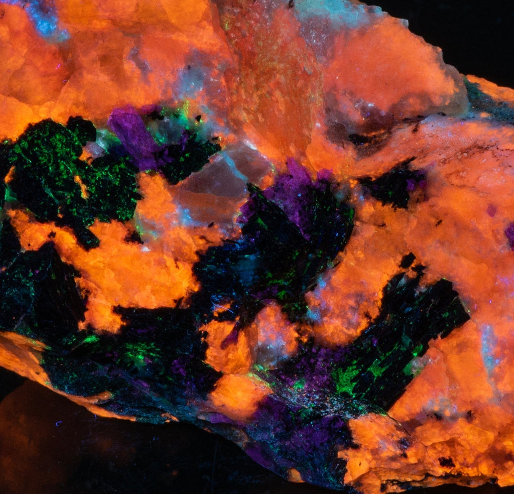 A piece of fluorescent sodalite with many unknown minerals