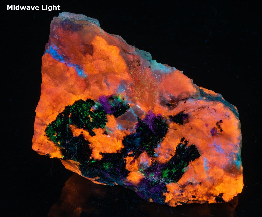 A piece of fluorescent sodalite with many unknown minerals