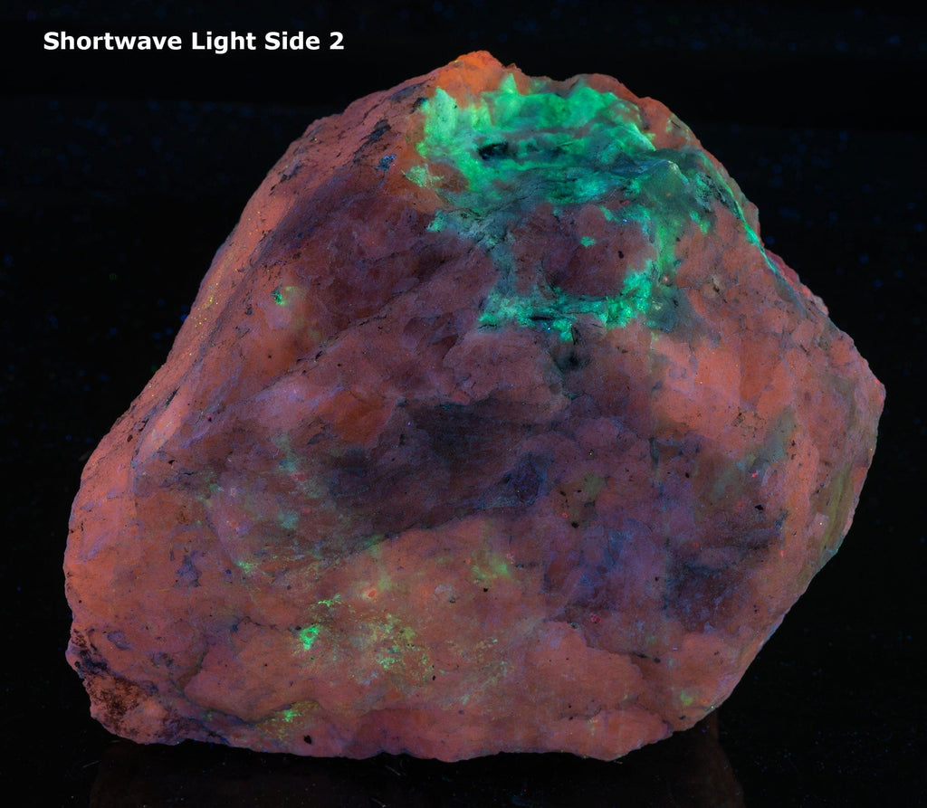 A large mineral specimen of fluorescing sodalite shown under all wavelengths