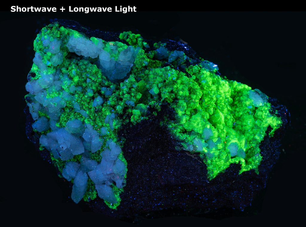 Sparkling, yellow-green, adamite crystals embedded in a limonite matrix along with larger, well-formed, white calcite crystals