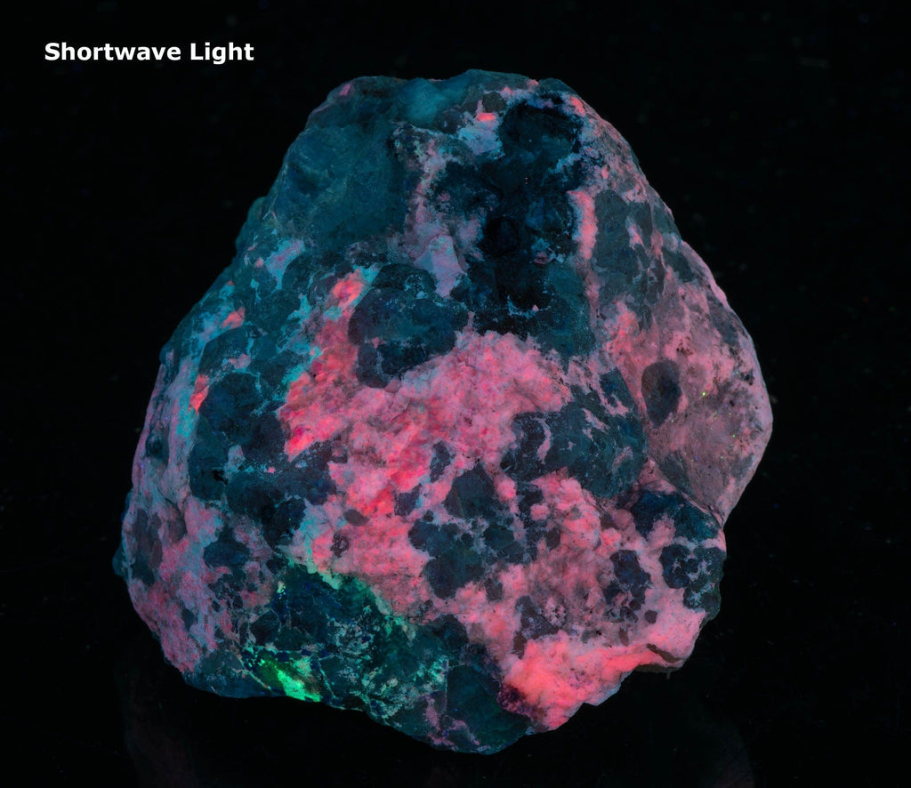 A mineral specimen of bright cherry red tugtupite from Greenland
