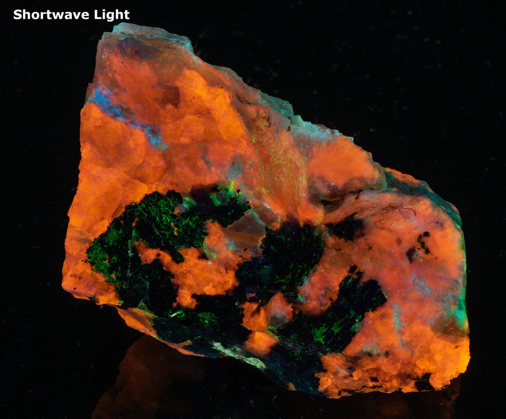 A piece of fluorescent sodalite with many unknown minerals