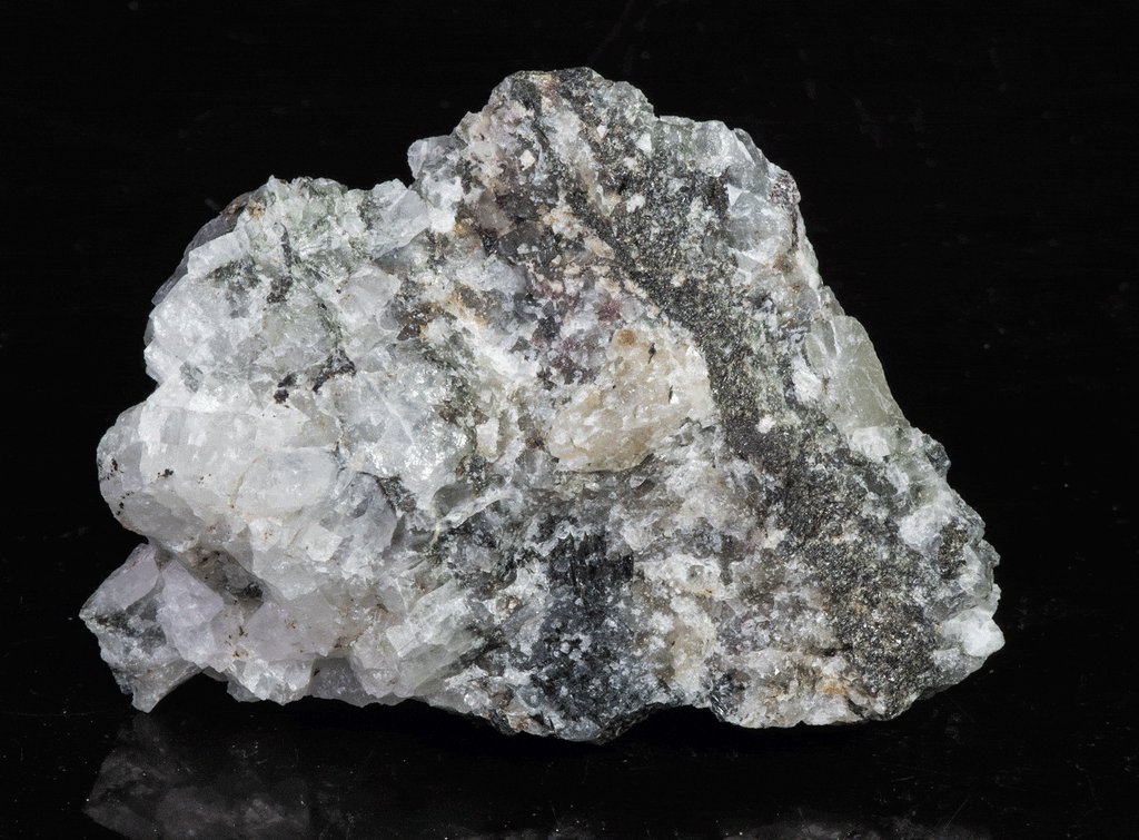 A miniature piece of fantasy rock containing tugtupite, sodalite and other rare minerals from Greenland