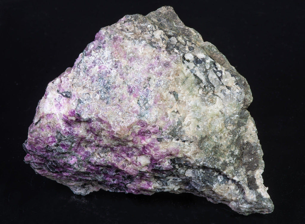 A large, tenebrescent fantasy rock with spectacular veined Tugtupite